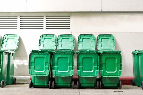 Separated recycling bins and stacked furniture ready for transfer